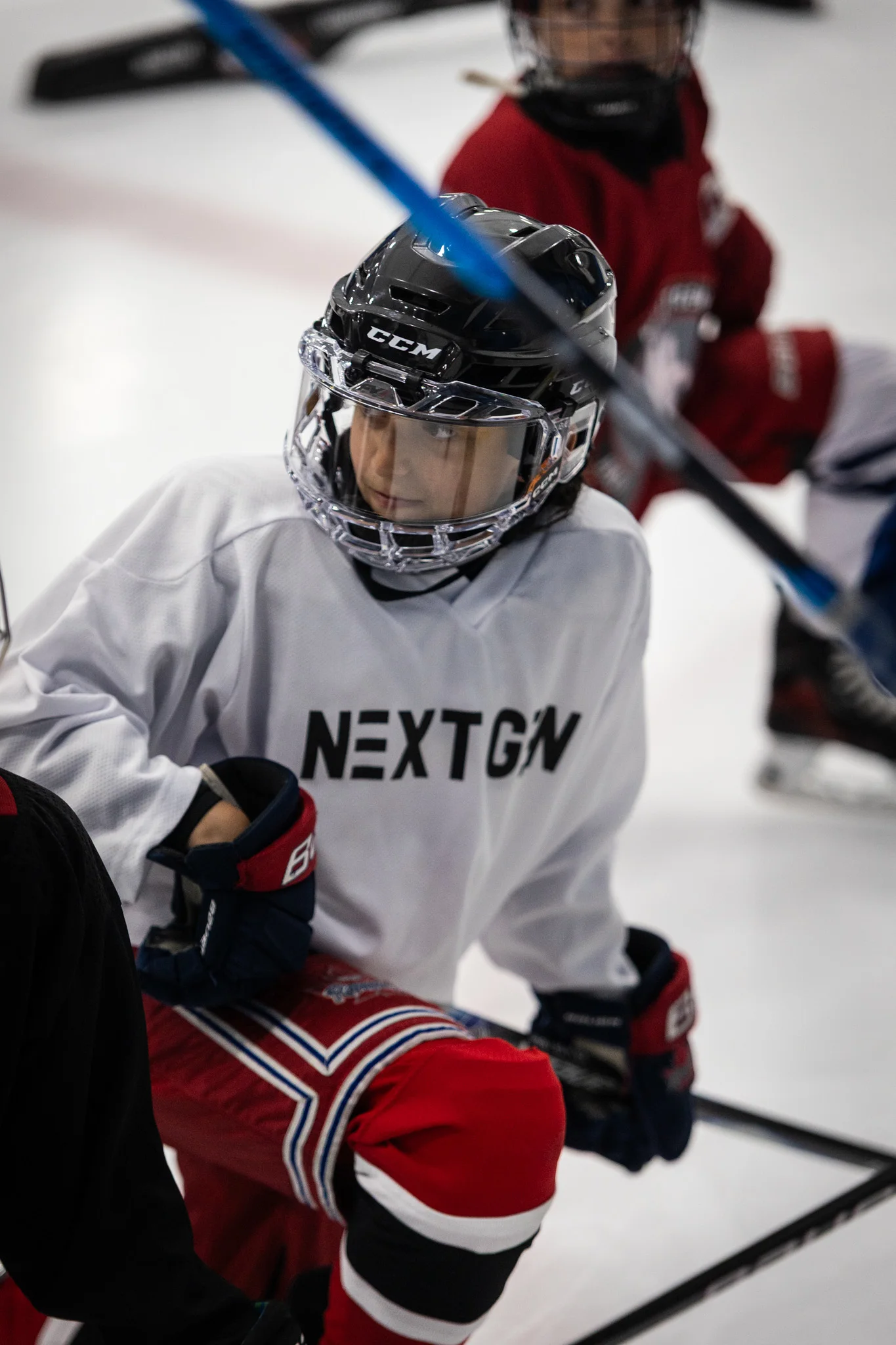 Coach Joe DeMarco leading a NextGen Hockey School on-ice session