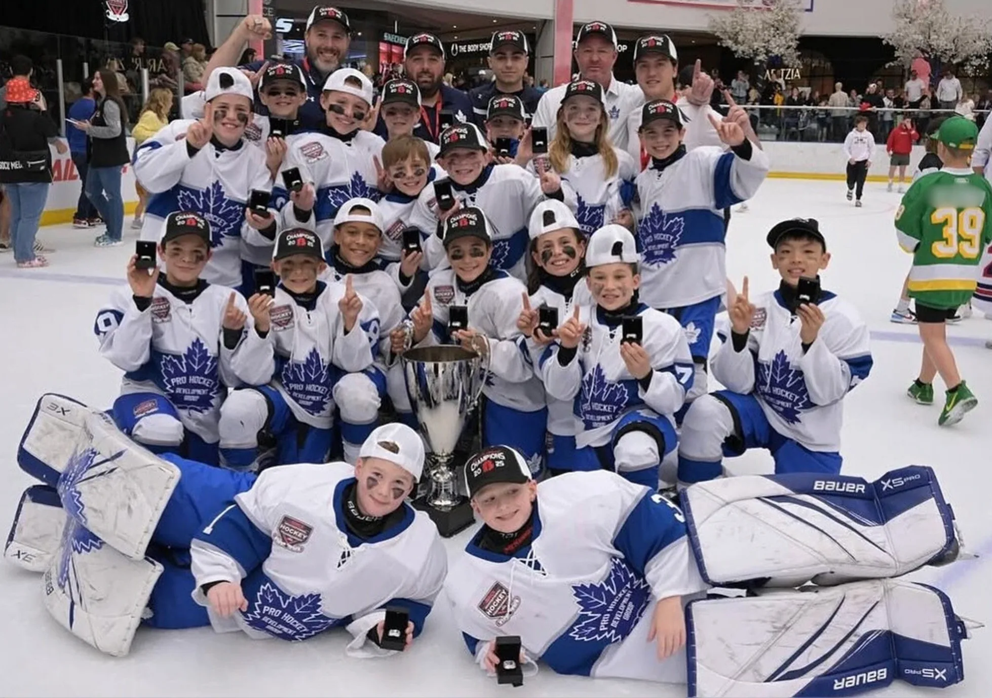 Coach Joe DeMarco and his team celebrating the 2025 Brick Invitational Tournament championship with the trophy